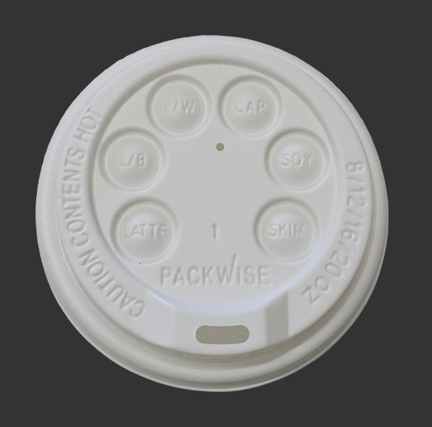 A white plastic disposable coffee cup lid with embossed text and labels including CAP, SOY, LATTE, and SKIM, on a dark gray background.