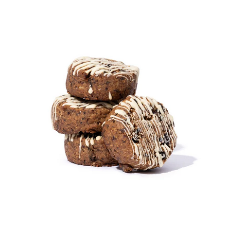 Stack of fruit cookies with white yoghurt drizzle on a white background