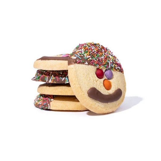 Decorative cookies shaped like a snowman with a smiling face on a white background